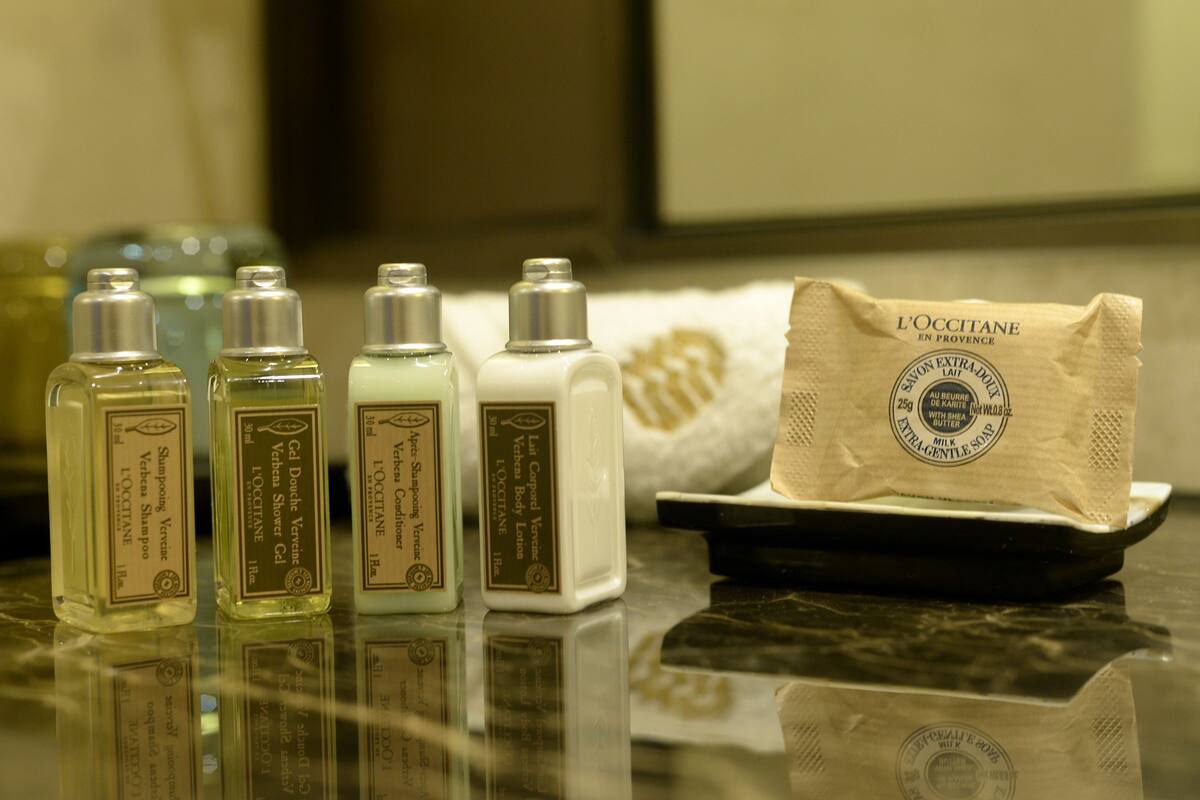 deluxe suite | bathroom | designer toiletries, hair dryer, slippers, towels