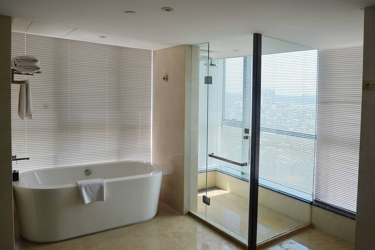 executive deluxe king room | bathroom | designer toiletries, hair dryer, slippers, towels