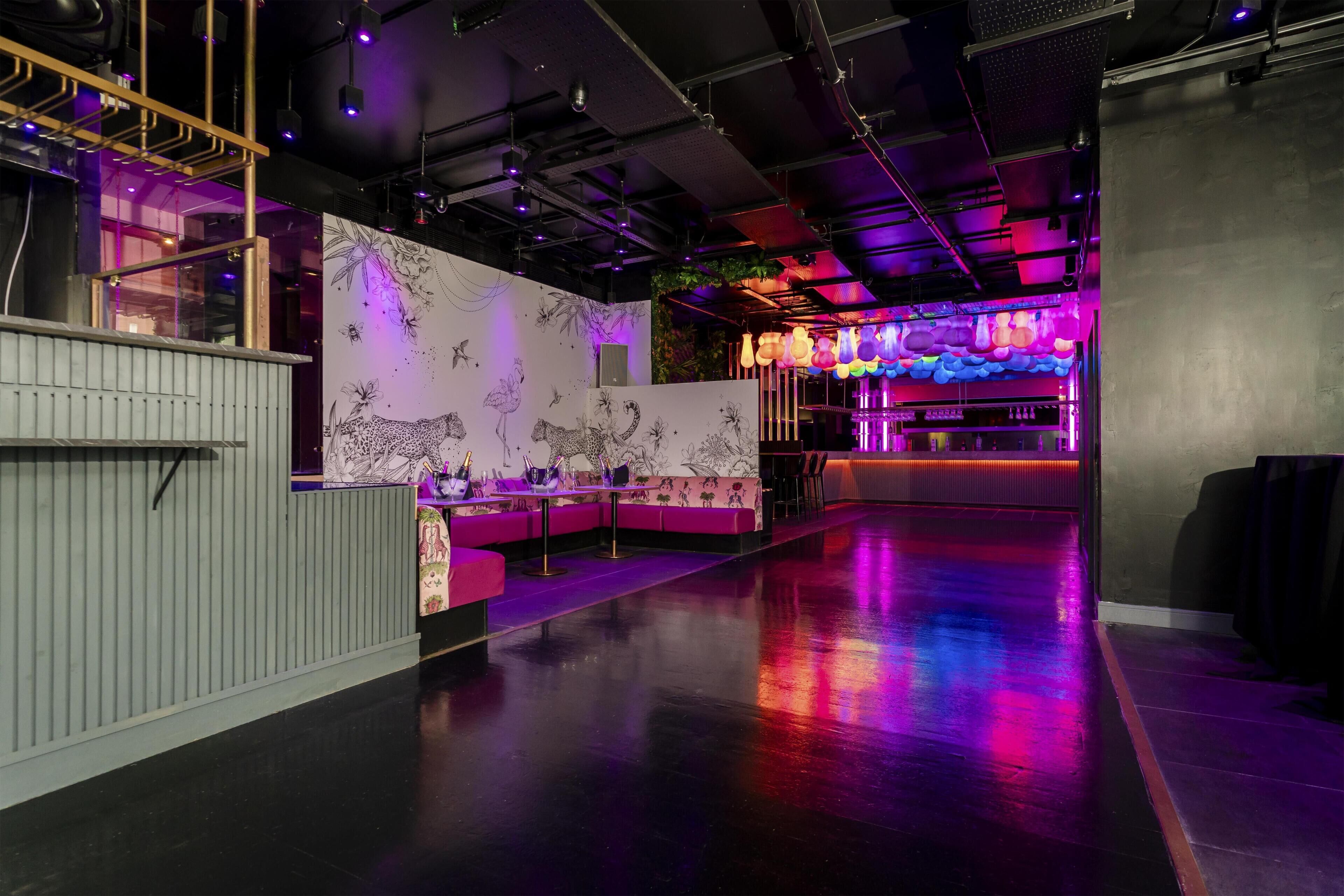 A modern interior with a bar area, seating, and a decorative wall.