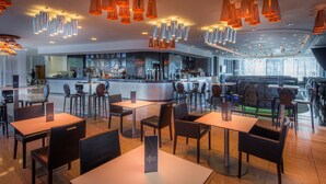 A modern restaurant with a bar area, multiple seating options, and contemporary lighting fixtures. - Hilton Liverpool City Centre (Liverpool)