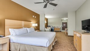 A hotel room with a large bed, a desk, a television, and a ceiling fan. - Holiday Inn Express Hotel Suites Lubbock Southwest-Wolfforth by IHG (Wolfforth)