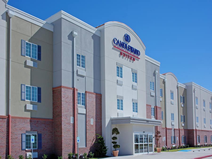 A multi-story hotel with a prominent sign for Candlewood Suites.