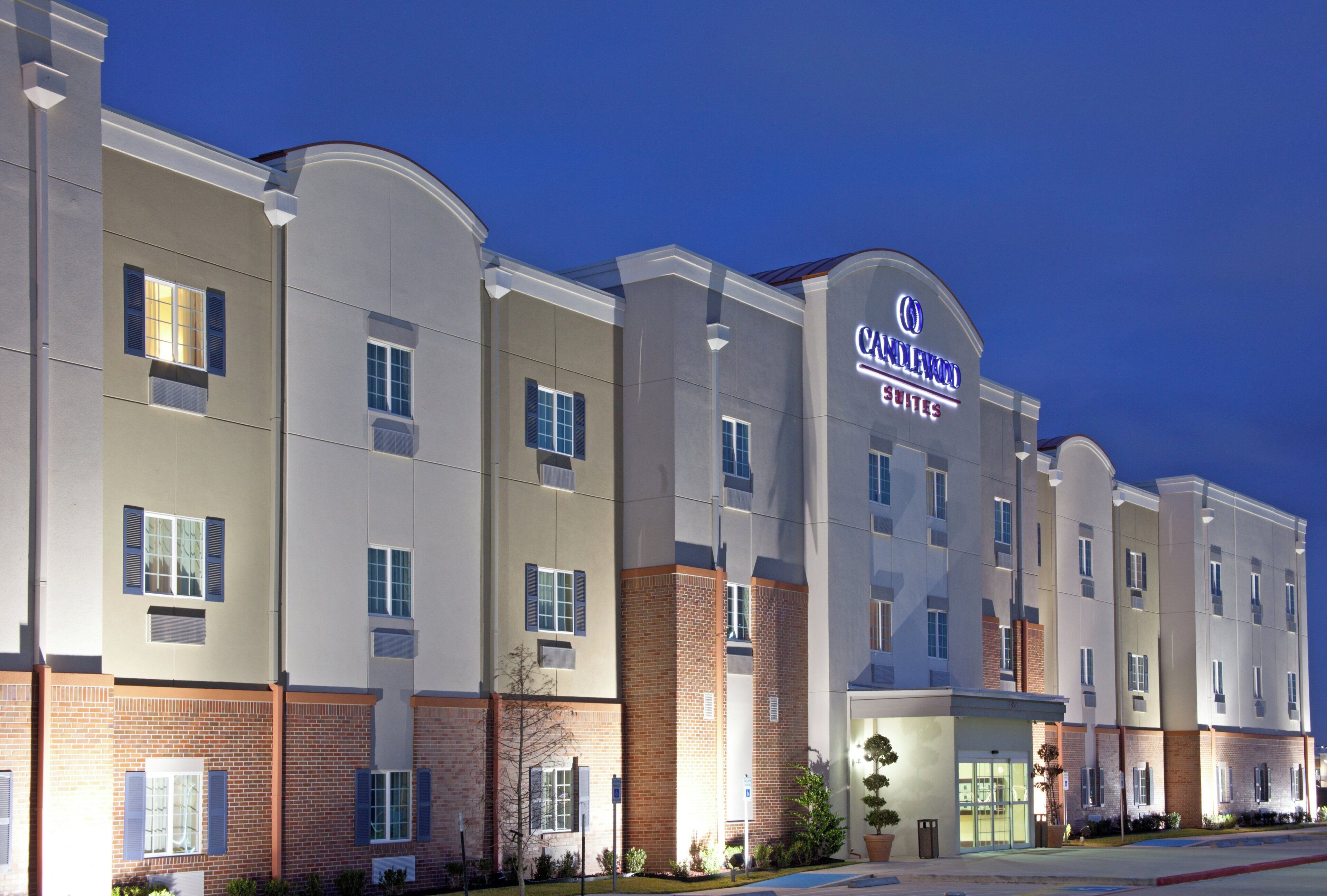 A hotel with a modern facade, multiple windows, and a prominent signage.