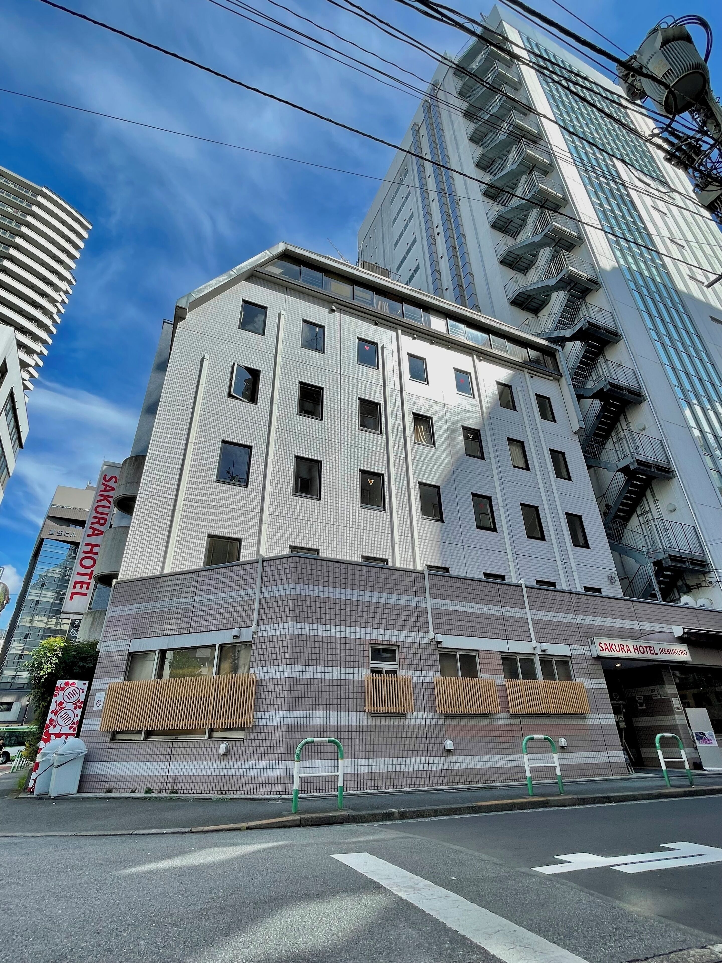 A multi-story building with a tiled facade and a sign for Sakura Hotel.