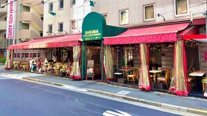 A Sakura Cafe & Restaurant with outdoor seating and a green awning. - Sakura Hotel Ikebukuro - Hostel (Tokyo)