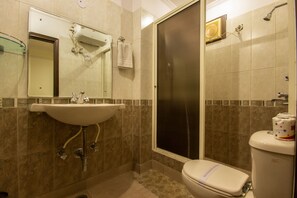 A bathroom with a sink, toilet, and shower. - Hotel Grand Park Inn (New Delhi)