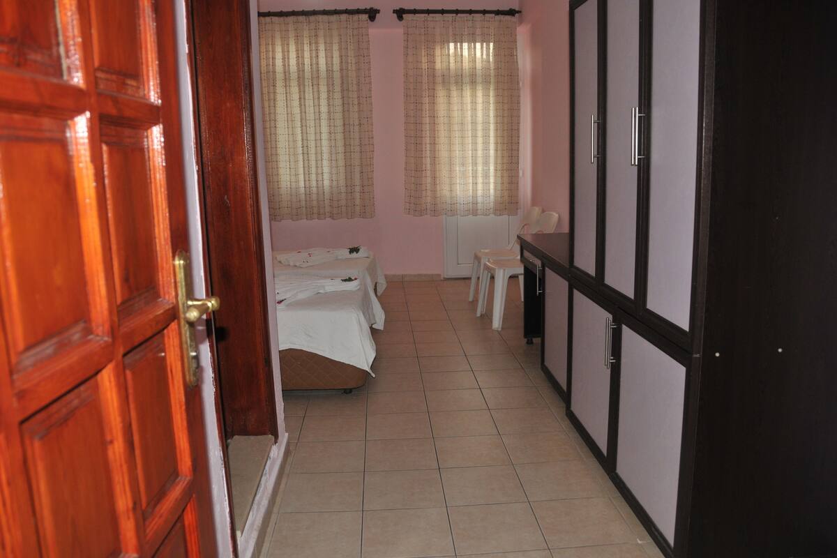 A room with a bed, a desk, and a chair.