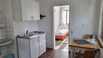 Standard Apartment (in guest house, 2 adults + 2 children) | Private kitchen | Electric kettle, high chair