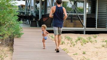 Walk along the beachside boardwalk to our building with expansive windows and a metal roof.