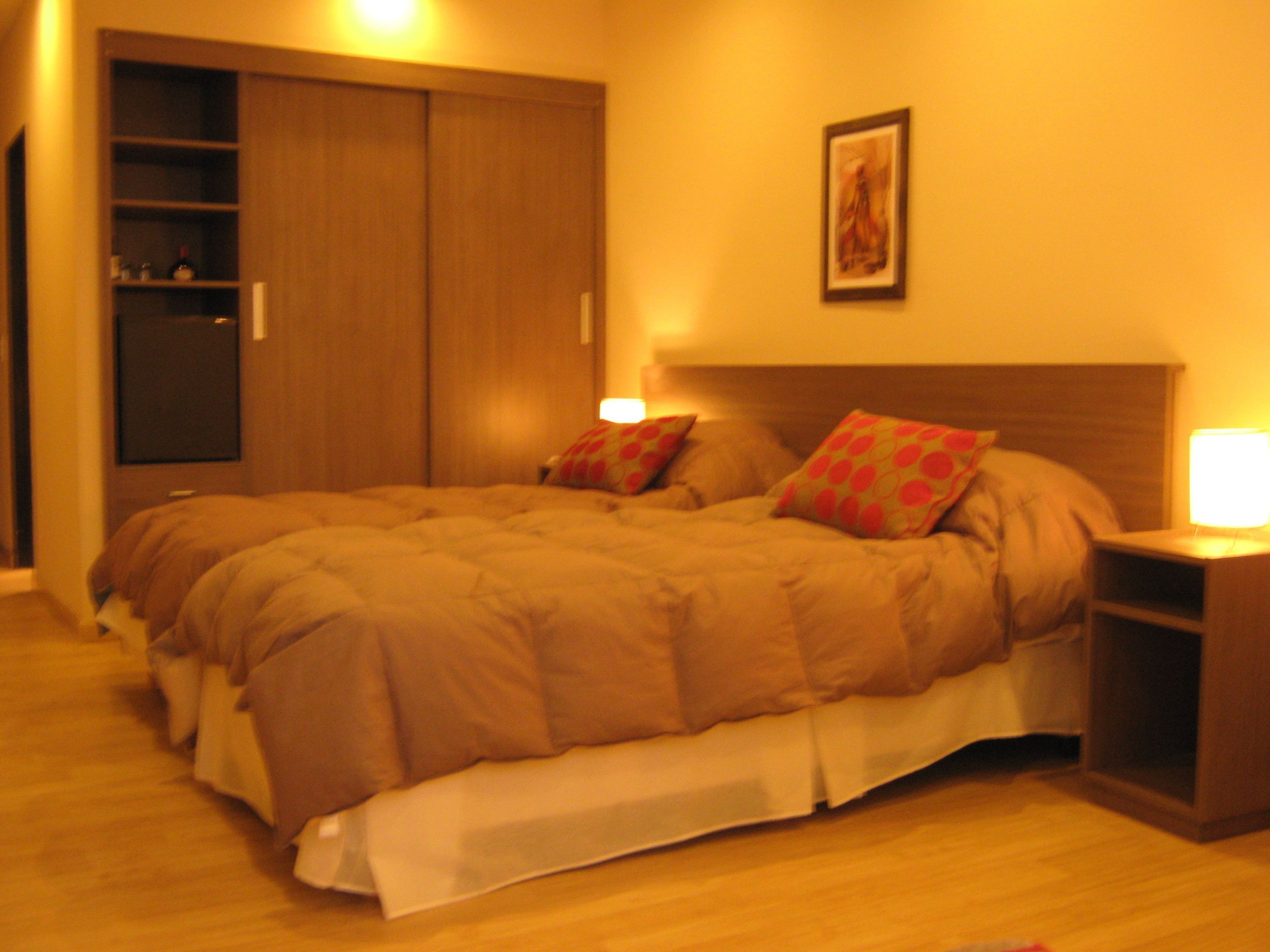 ميني بار وخزنة داخل الغرفة وملاءات أسرّة