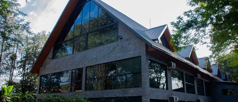 A modern building with large windows and a sloped roof.