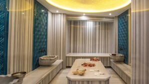 A luxurious spa room with a marble reception desk, a massage table, and a large mirror. - Martinenz Hotel (Istanbul)