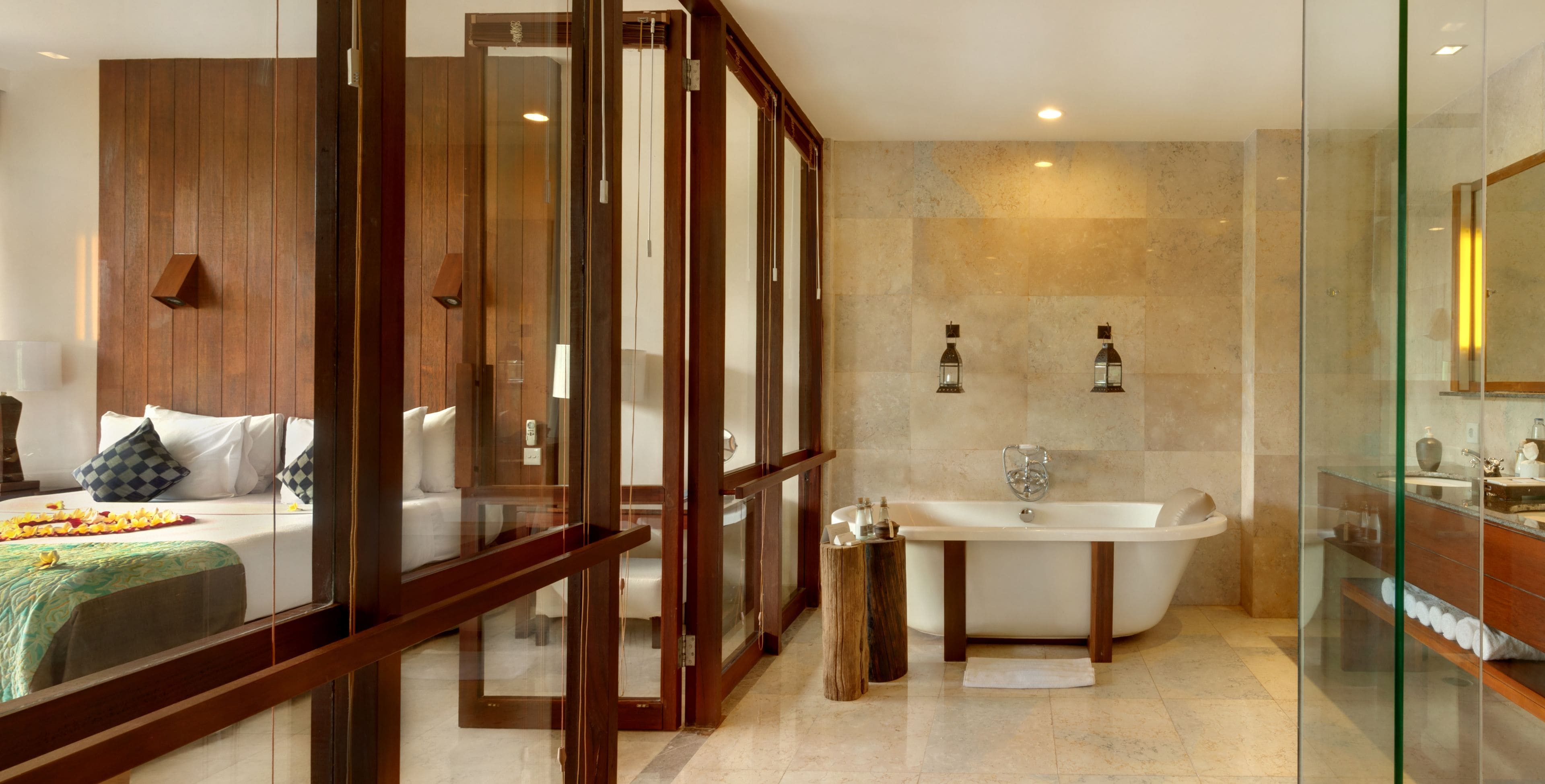 A modern bathroom with a freestanding bathtub, a glass-enclosed shower area, and a wooden vanity.