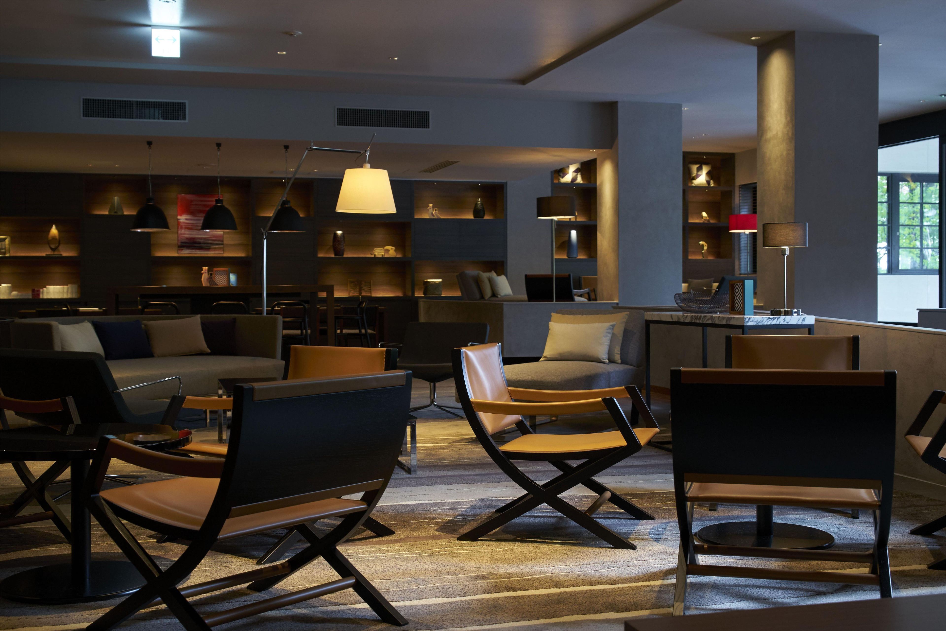 A modern interior with seating, bookshelves, and ambient lighting.