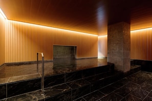 A modern bathroom with a wooden slatted wall design, a marble floor, and a central column. - Kyukaruizawa Kikyo, Curio Collection by Hilton (Karuizawa)