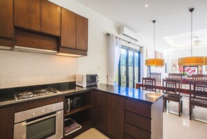 Full-size fridge, microwave, cookware/dishes/utensils