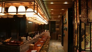 A long dining table with chairs, overhead hanging lamps, and a tiled floor. - City Viva Hotel Macau (Macau)