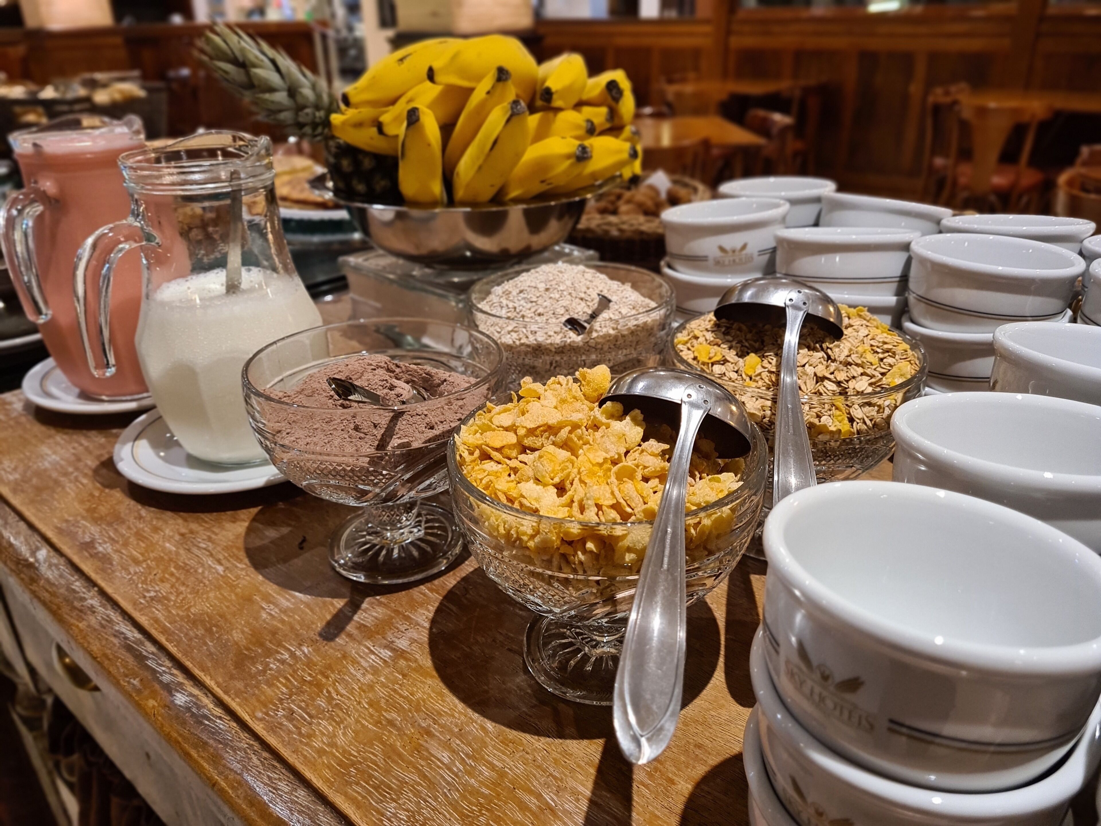 A breakfast buffet with various food items and utensils.