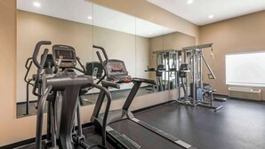 A gym with treadmills, elliptical machines, and weightlifting equipment. - Quality Inn & Suites Groesbeck North (Groesbeck)