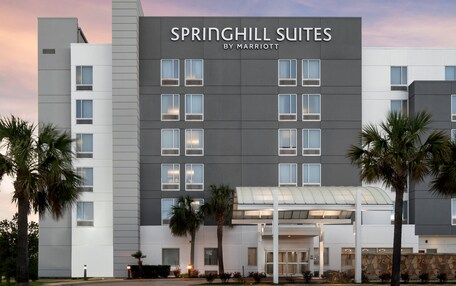 A modern hotel building with a sign reading "SPRINGHILL SUITES BY MARRIOTT".