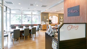 A restaurant with a wooden interior, a sign reading "Flora", and a counter with a bicycle logo. - Ginza Capital Hotel Main (Tokyo)