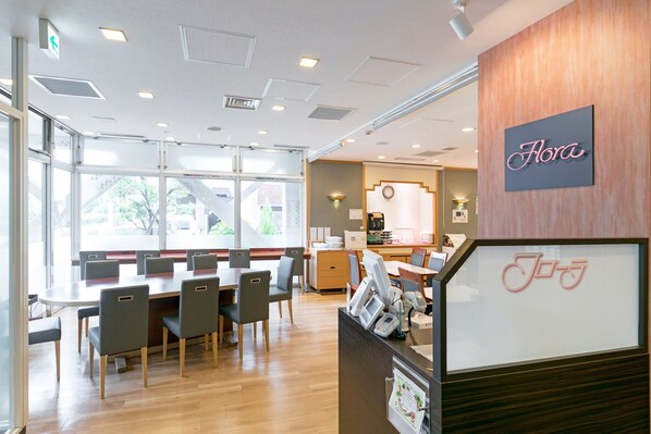 A restaurant with a wooden interior, a sign reading "Flora", and a counter with a bicycle logo. - Ginza Capital Hotel Main (Tokyo)