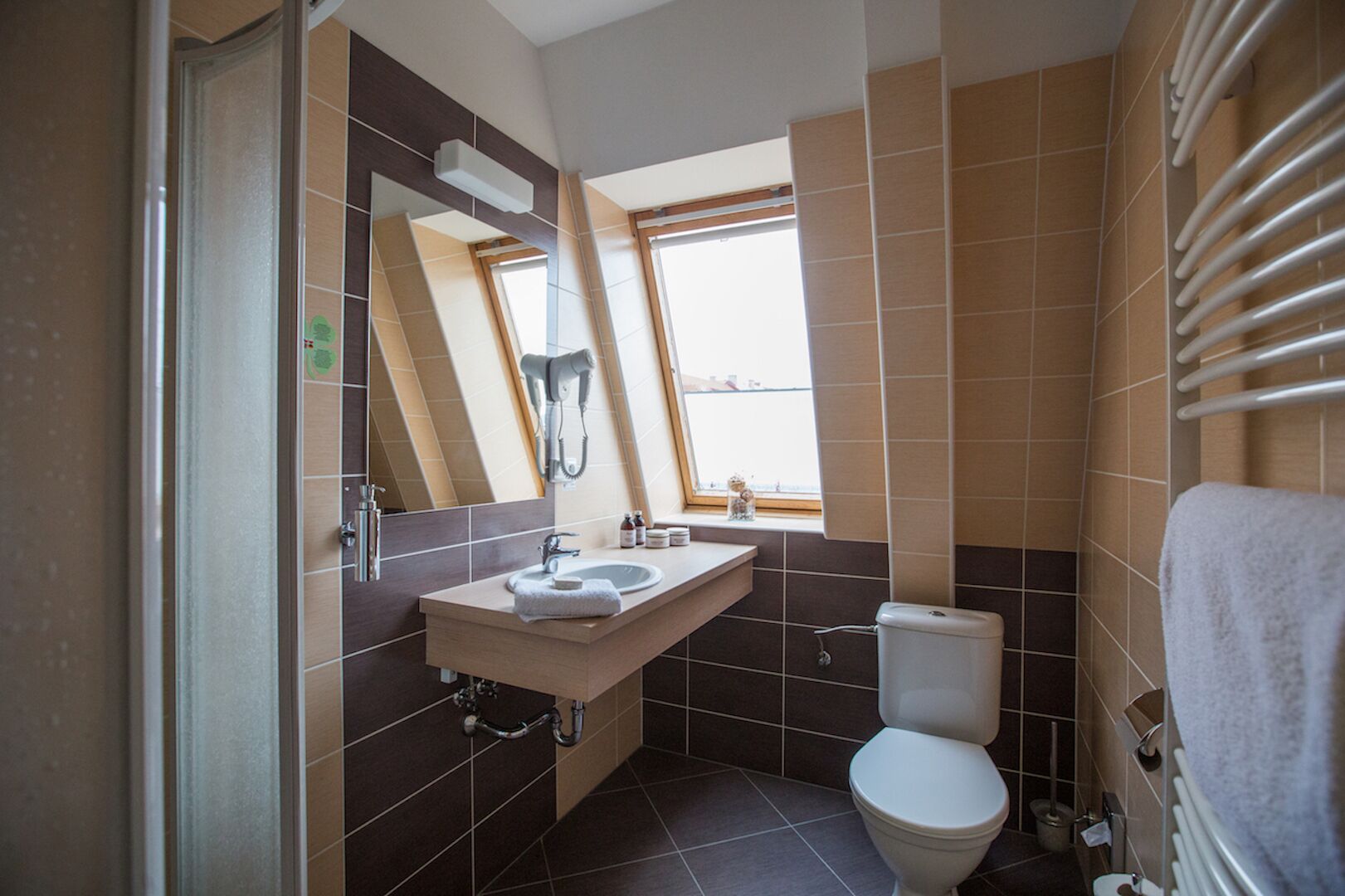 Een moderne badkamer met een raam, een wastafel en een toilet.