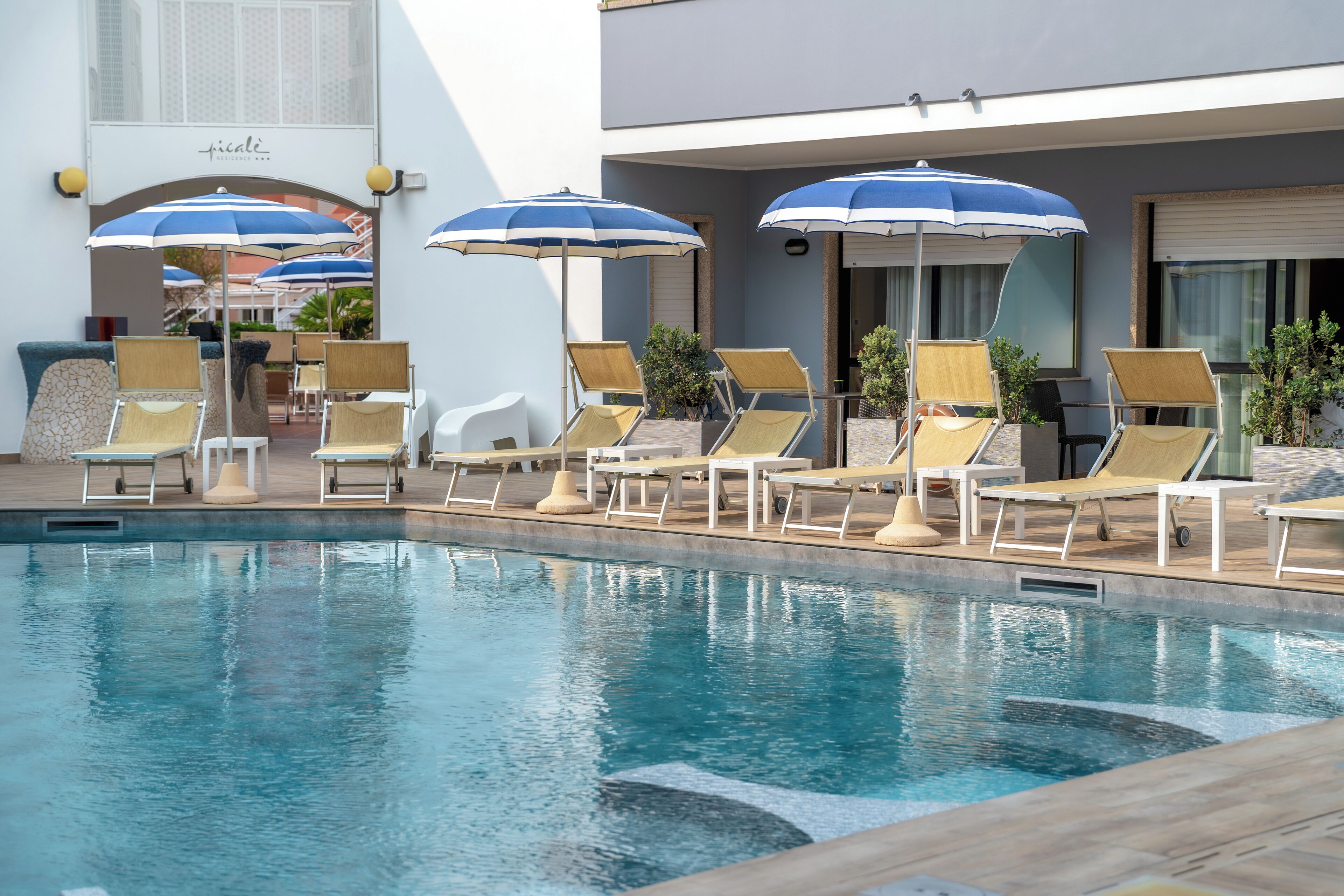 seasonal outdoor pool, open 9:00 am to 7:00 pm, pool umbrellas