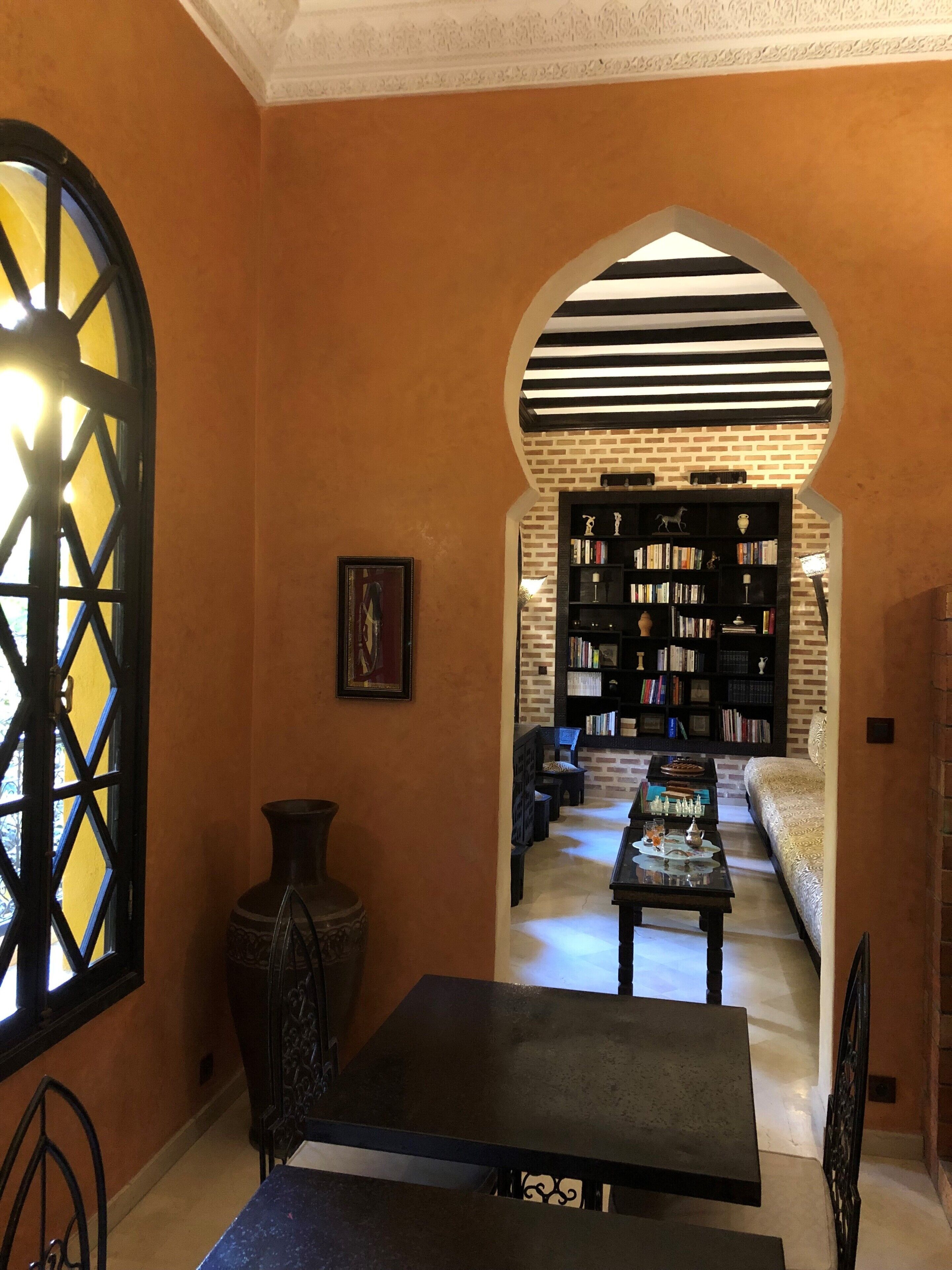 A library with bookshelves, a table, and a chair.