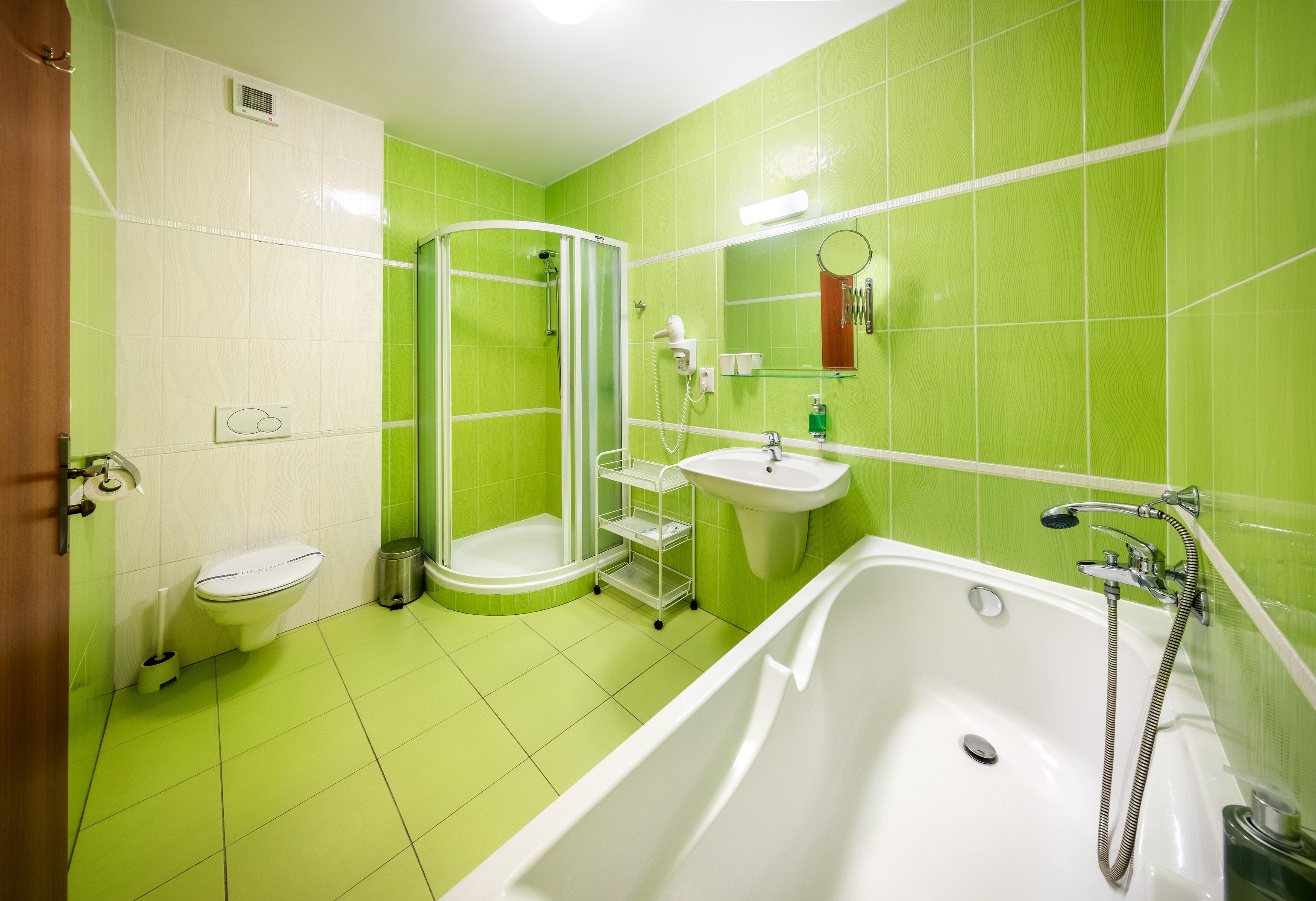 A bathroom with a shower, toilet, sink, and bathtub.