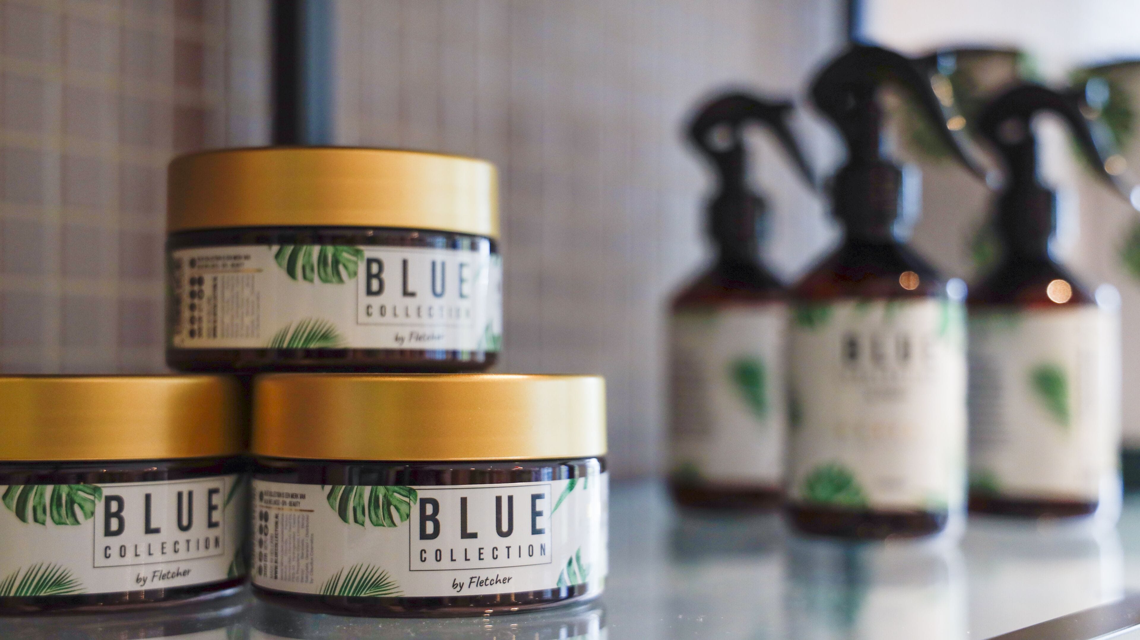 Three containers of 'Blue Collection' by Fletcher on a reflective surface.