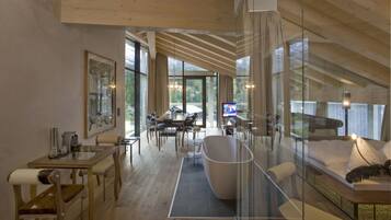A spacious loft-style room with a high ceiling, large windows, and a modern interior design.