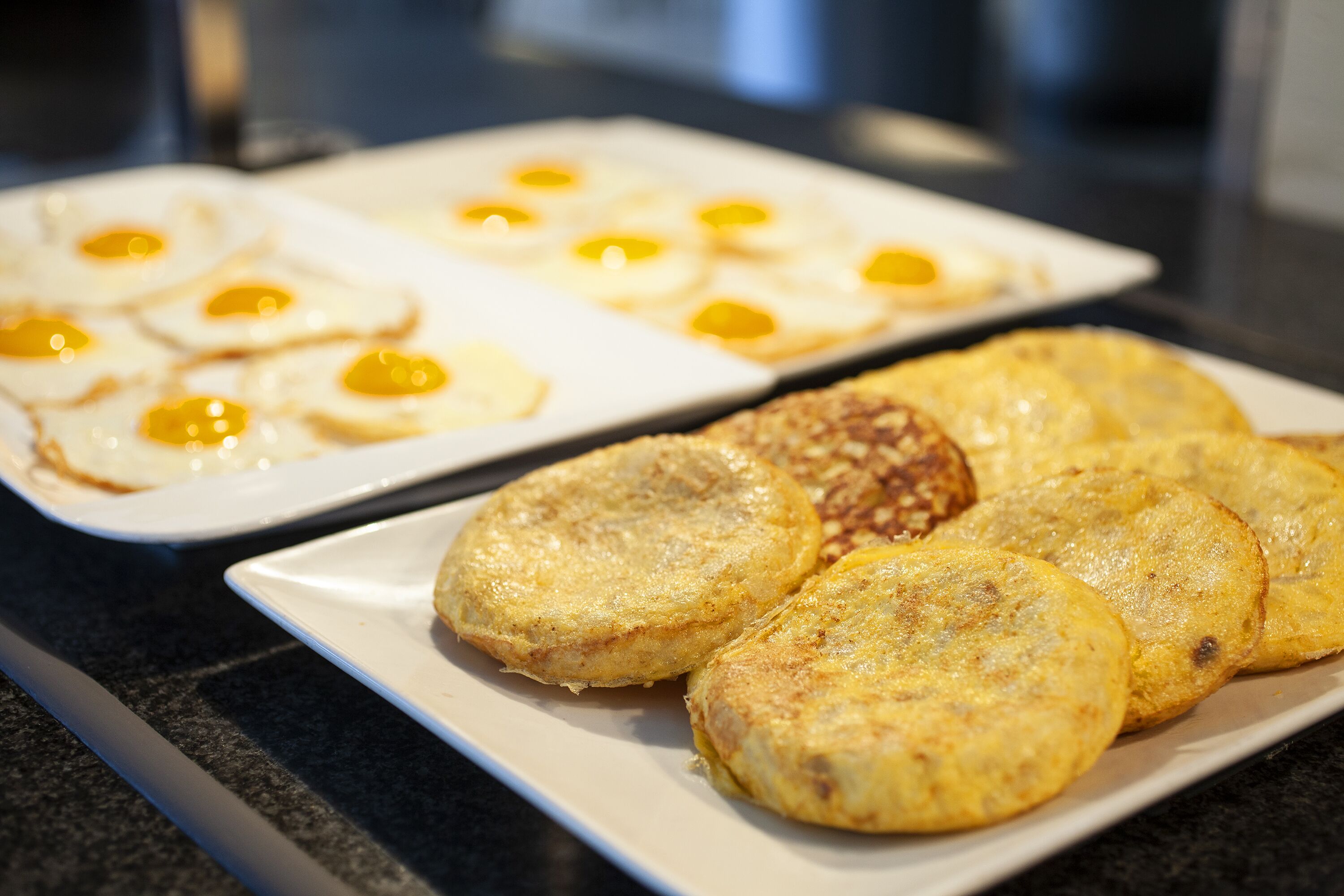 A breakfast plate with eggs and hash browns.