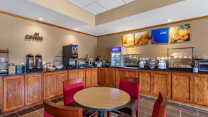 A modern coffee shop with wooden cabinets, a coffee machine, and a seating area with red chairs. - Comfort Inn & Suites Carbondale University Area (Carbondale)