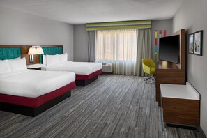 A hotel room with two beds, a desk, a chair, a TV, and a window with curtains. - Hampton Inn & Suites Parsippany/North (Parsippany)