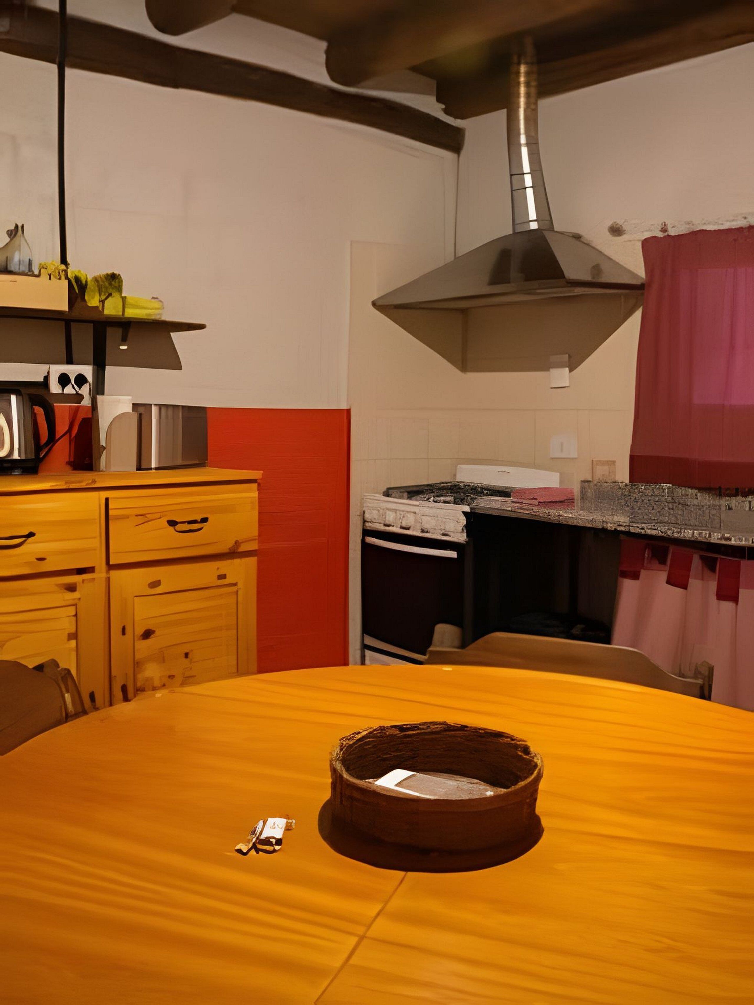 A kitchen with a wooden table, a cake, and a hanging pot rack.
