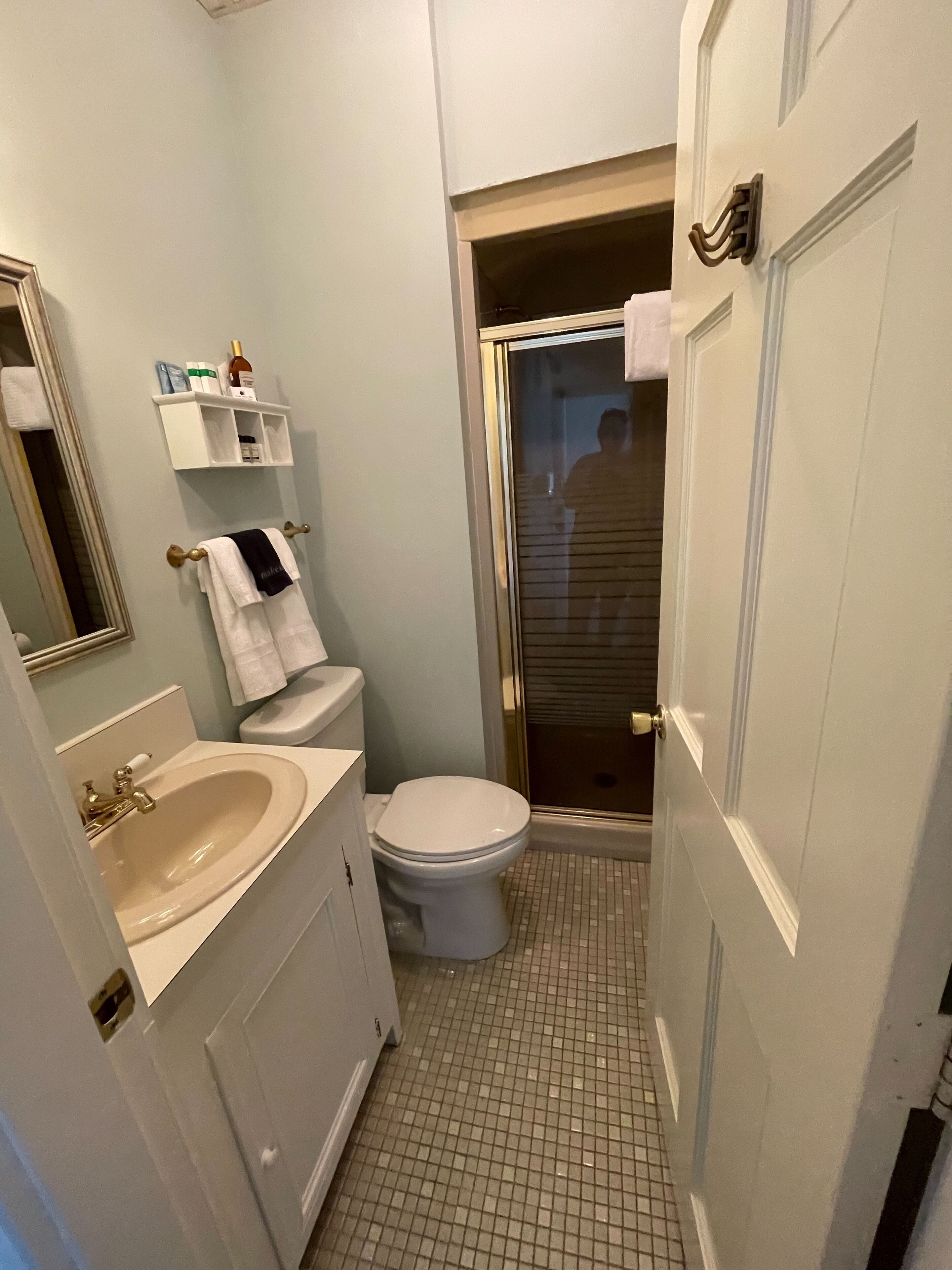 A bathroom with a sink, toilet, and shower.