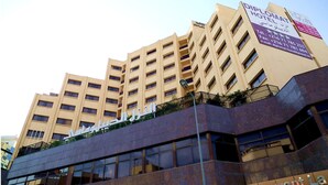 A multi-story hotel with a prominent sign in Arabic. - Hotel Diplomat (Tunis)