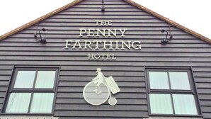 The exterior of The Penny Farthing Hotel with a classic design, including a bicycle symbol indicating bicycle-friendly facilities. - The Penny Farthing (Berkhamsted)