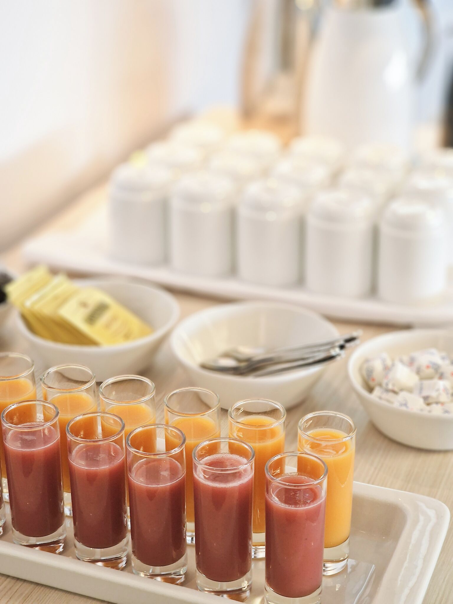 A breakfast tray with various drinks and food items.