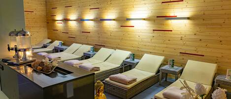 A spa area with massage chairs, a Buddha statue, and a reception desk.