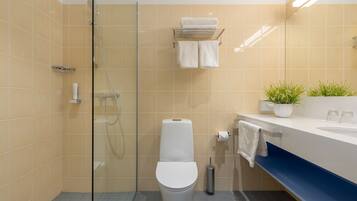 A modern bathroom with a glass-enclosed shower, a white toilet, and a sink with a blue countertop.