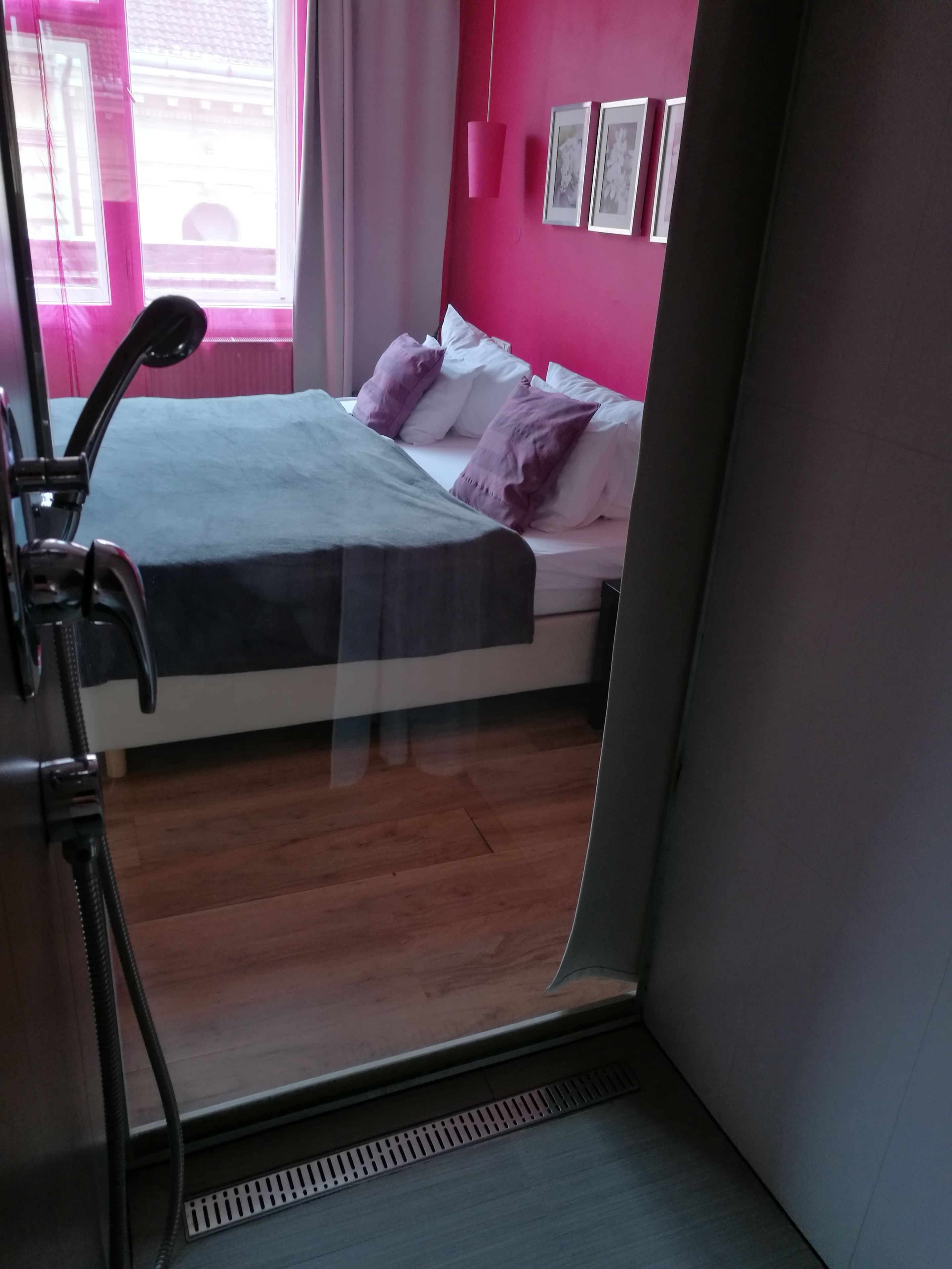 A room with a bed, a window, and a radiator.