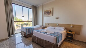 A hotel room with two beds, a large window, a painting on the wall, and a nightstand. - Hotel Dan Inn Barretos By Nacional Inn  (Barretos)