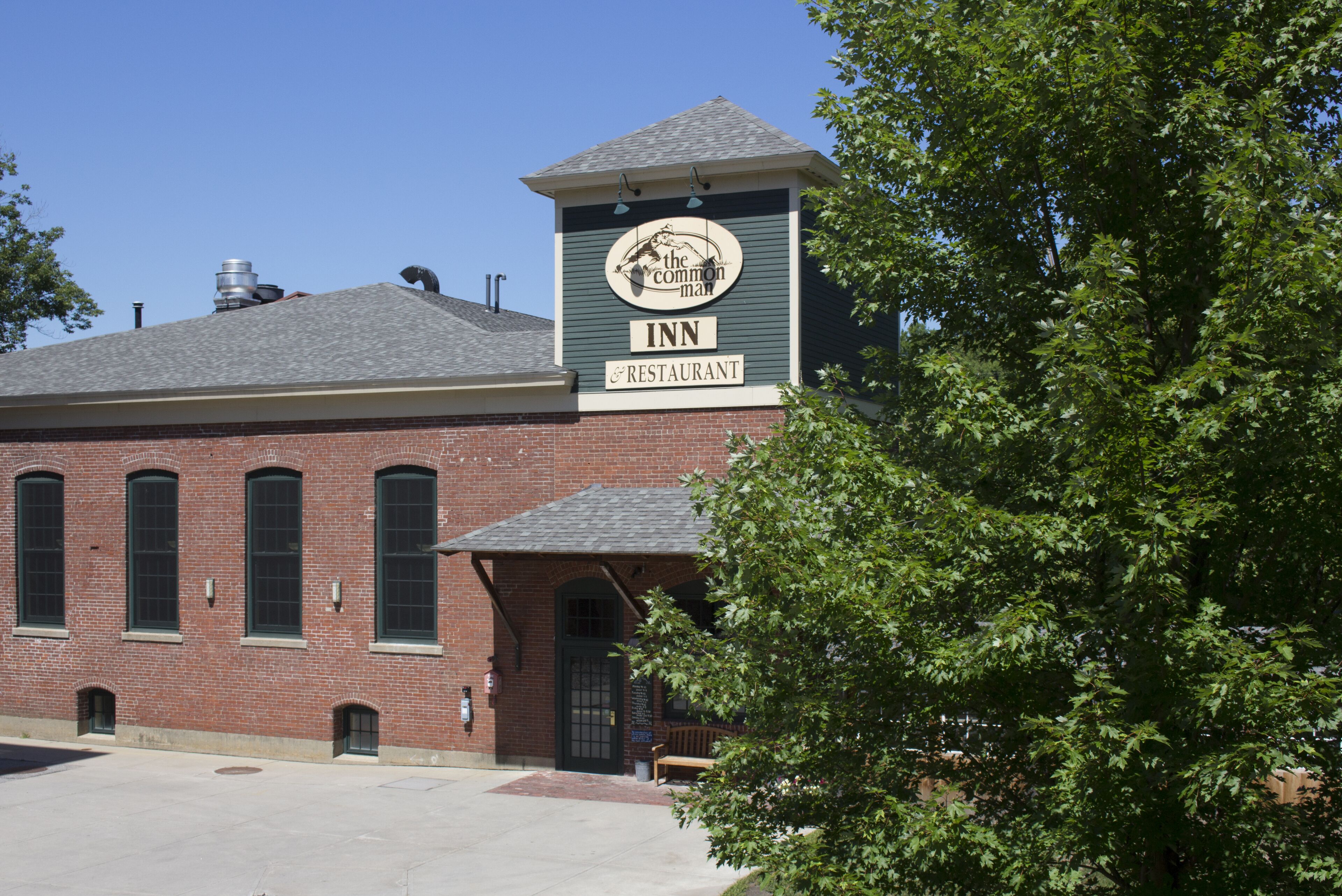 A brick building with a sign for 'The Common Man Inn & Restaurant'.