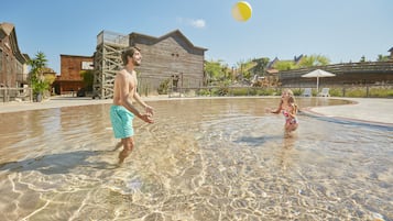 Relax by the tranquil pool surrounded by a wooden deck and comfortable seating.