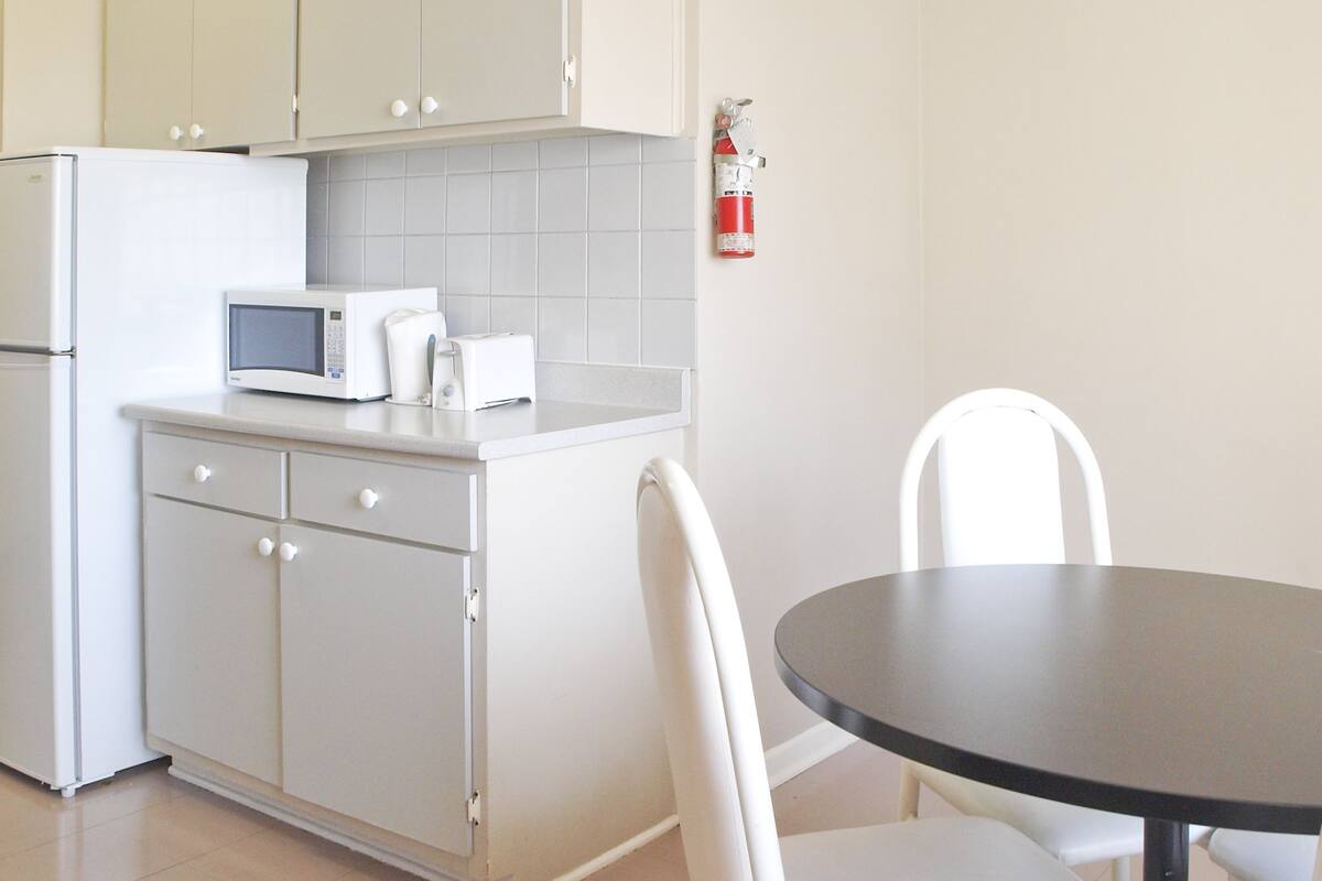 Fridge, microwave, coffee/tea maker, cookware/dishes/utensils