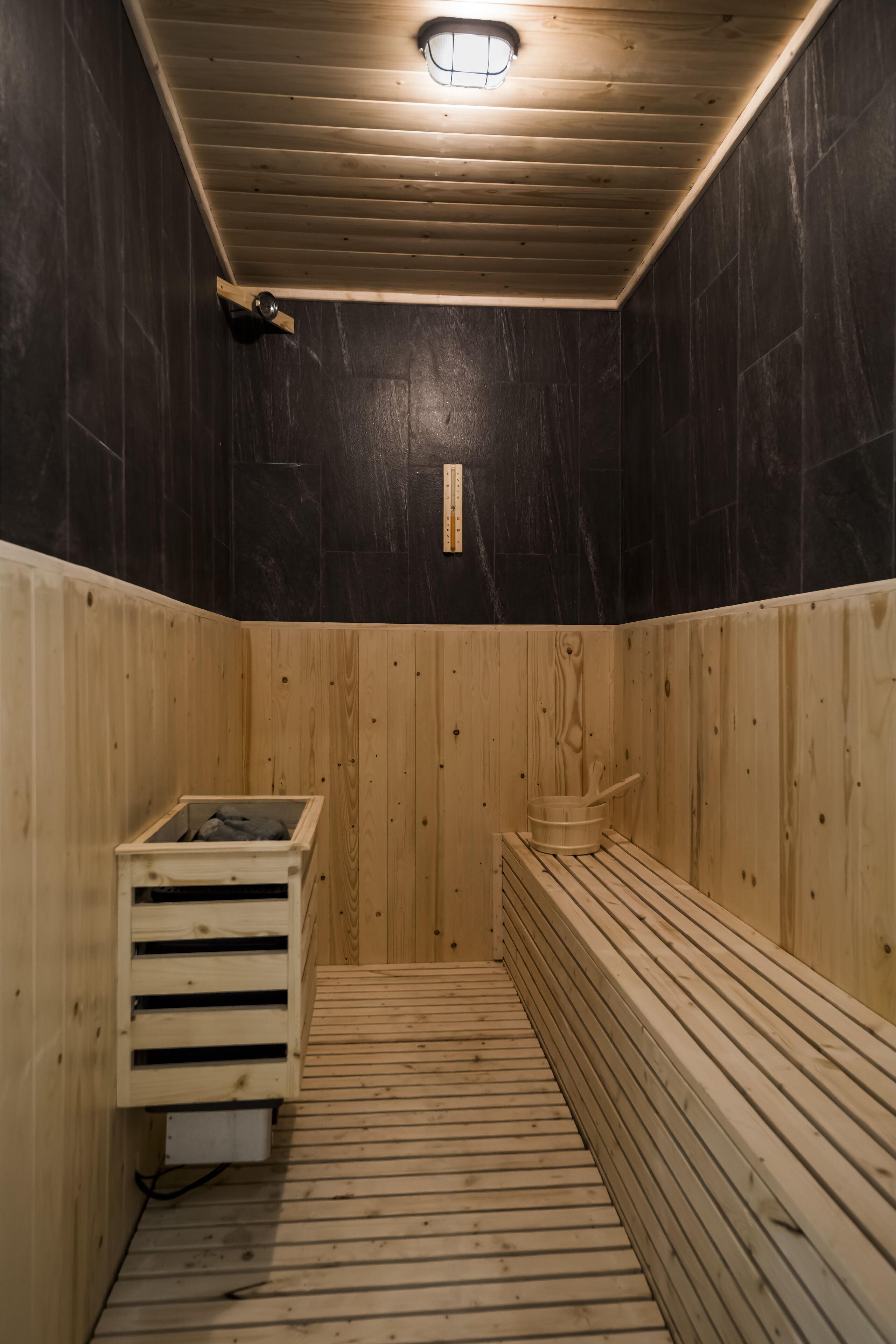 A sauna with wooden walls and a bench.