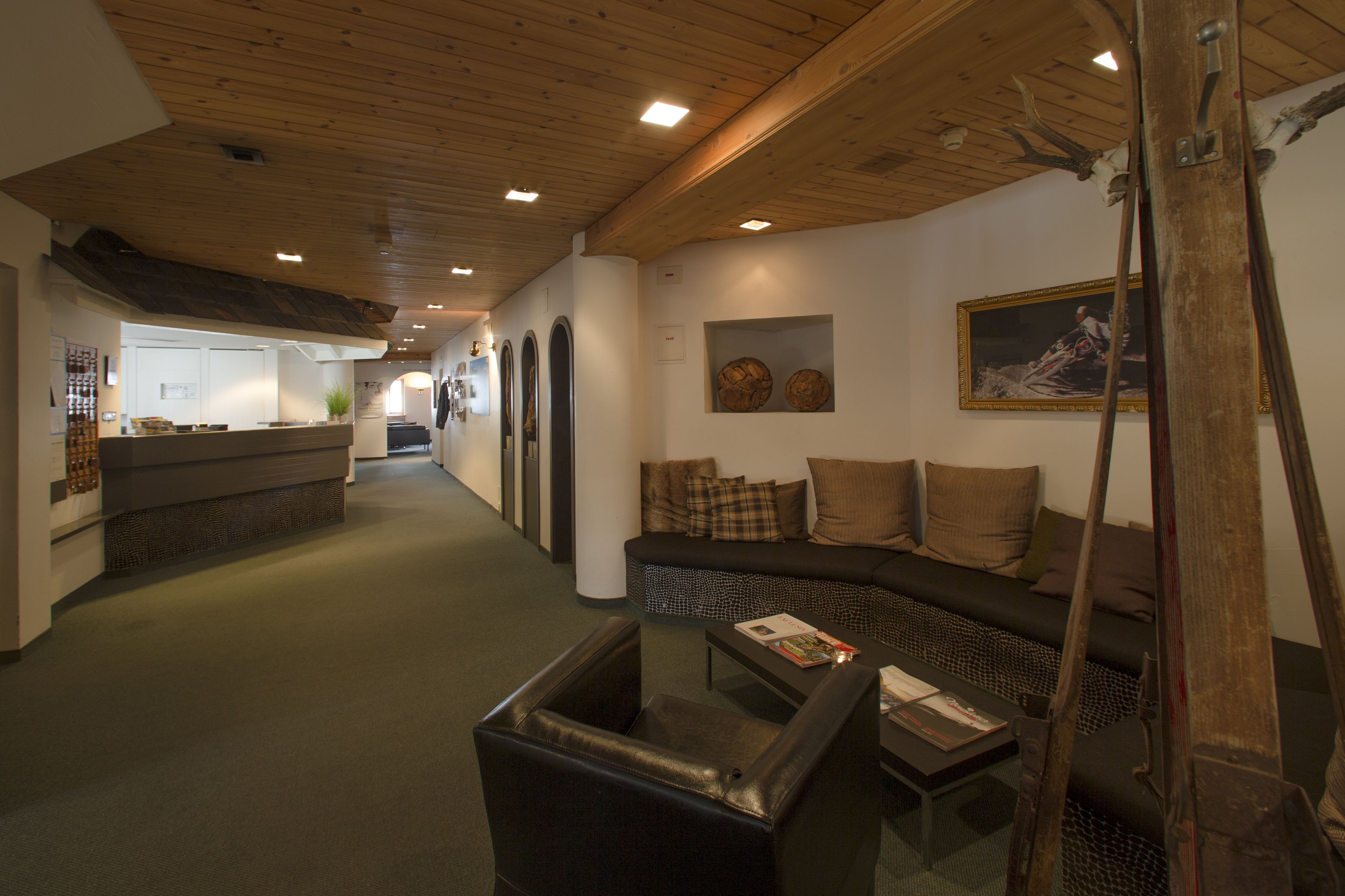 A hallway with a sofa, a coffee table, and a ski lift in the foreground.