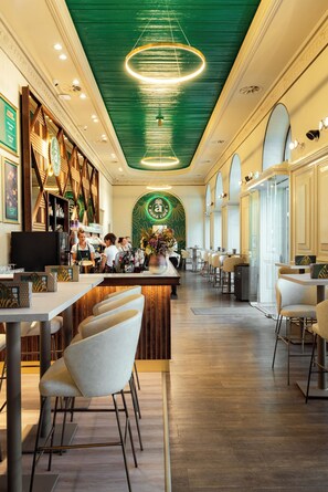 A restaurant interior with a bar area, seating, and a green ceiling. - Trendy Deluxe Apartments (Budapest)